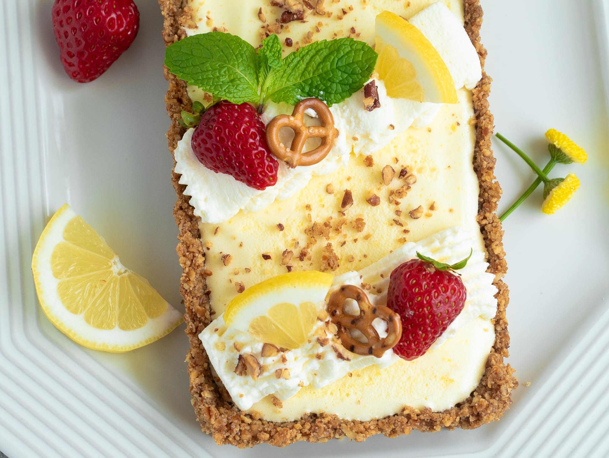 Lemon Rectangular Tart with Strawberries and garnished with Lemon slices and mint