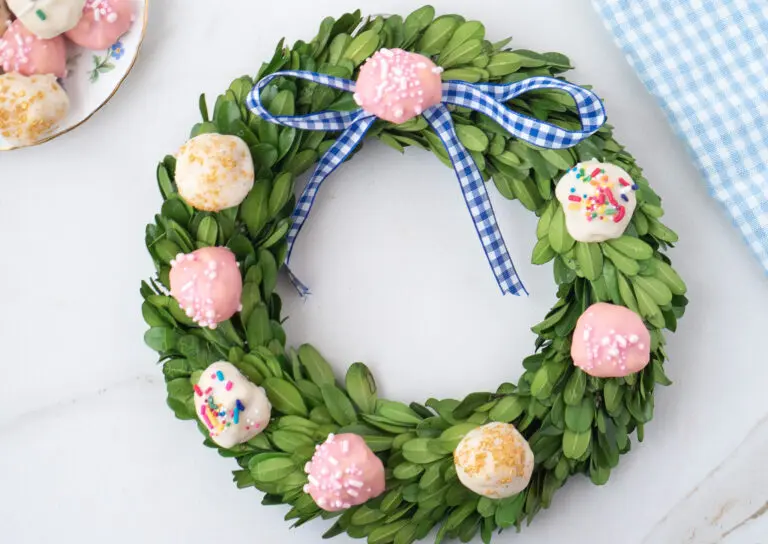 holiday wreath with round Italian Wedding Cookies on top and a blue and white gingham bow Italian Wedding Cookie Recipe