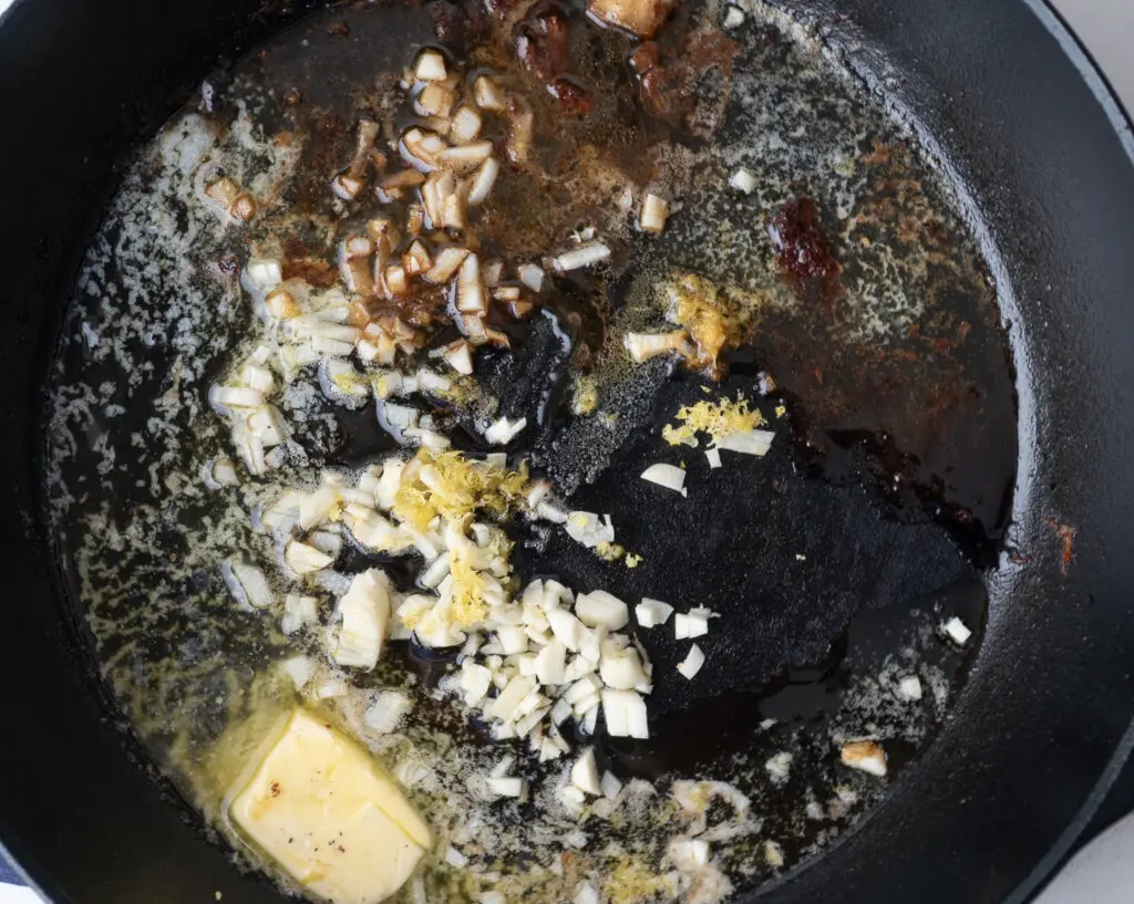 Skillet with butter garlic and lemon zest cooking