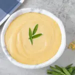 Creamy Mustard Sauce Recipe | In a bowl with a blue gingham tray and herbs