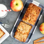 Jewish Apple Cake Quick bread Recipe apples and glass of milk with red and white striped straw and cinnamon sticks