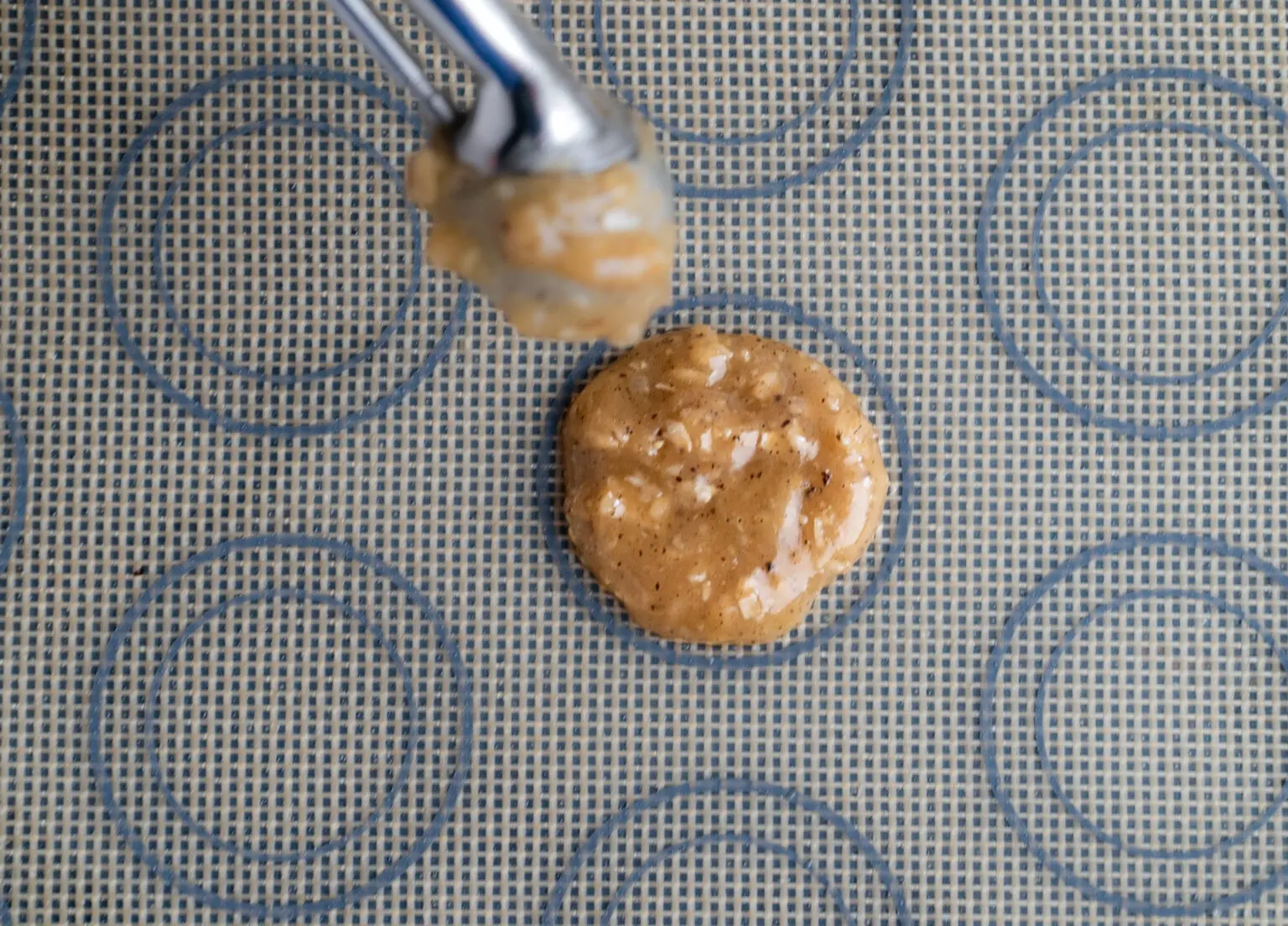 Scooping Brown Butter Irish Lace Cookies Recipe on a baking tray CLOSE UP