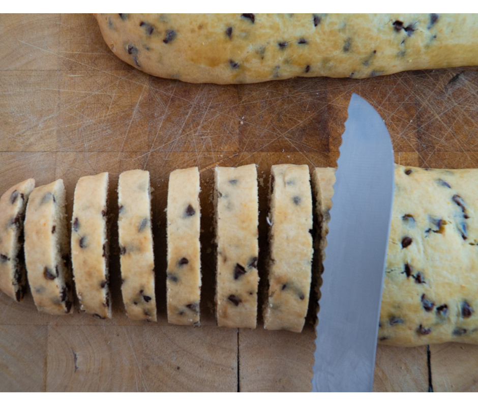 Slicing baked chocolate chip biscuits