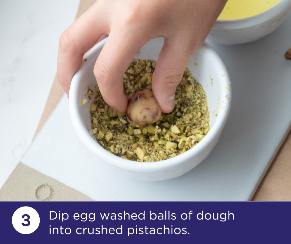 Roll dough ball in finely chopped pistachios | Pistachio Cherry Charmers Recipe