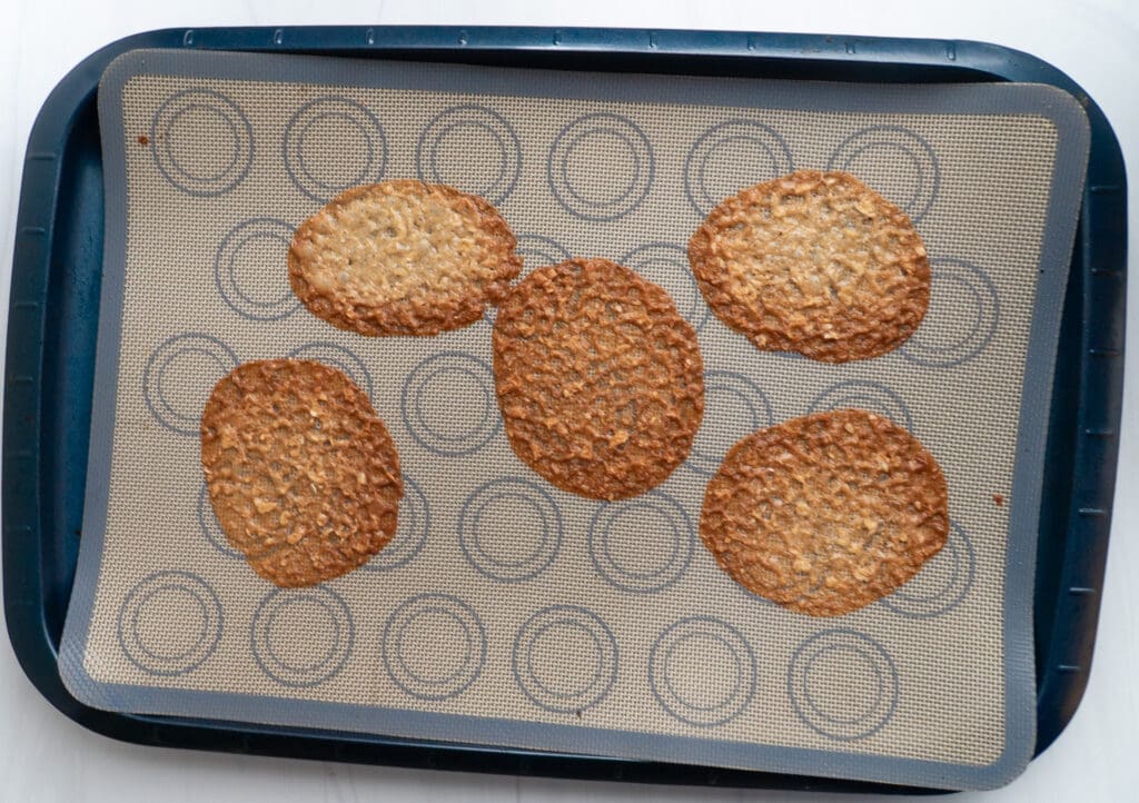 Brown butter Irish lace cookies cooked and cooling on a tray