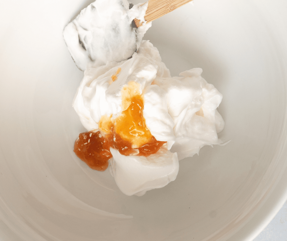 Rubber Spatula folding apricot preserves into egg whites