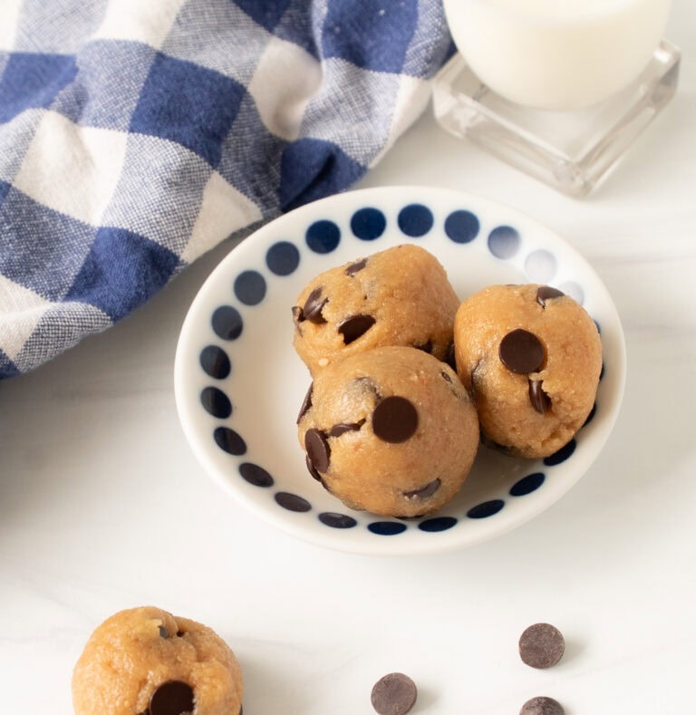 Healthy chocolate chip cookie dough protein bites on a blue and white napkin, ready for snacking