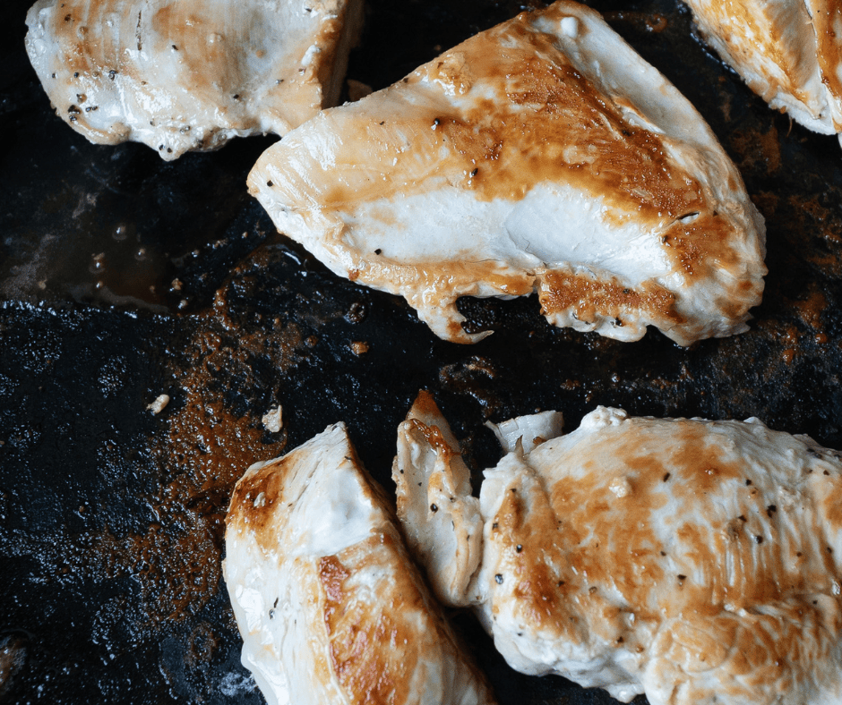 Golden chicken cooking on a cast iron pan for Teriyaki Chicken Bento Box