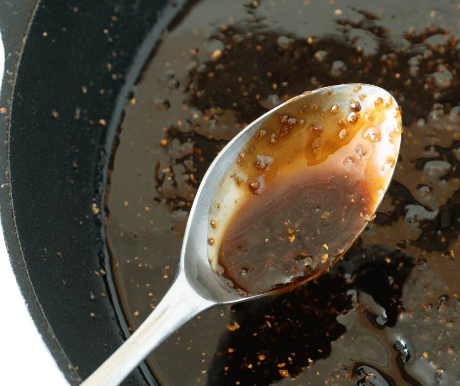 Teriyaki Sauce cooking in a pan and shown with a spoon for Teriyaki Chicken Bento Box