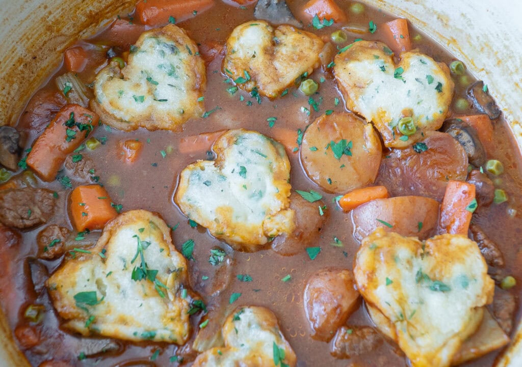 Beef Stew with Herb Dumplings simmering on stew.
