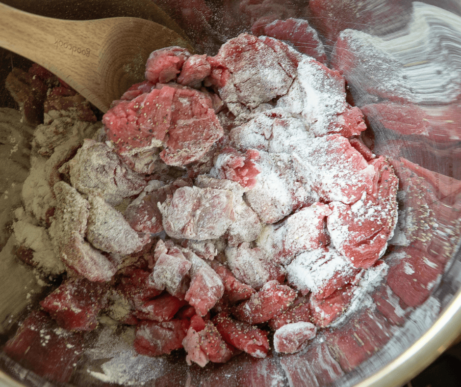 Uncooked beef stew beef cubes coating with flour 