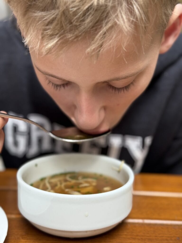 boy eating Austrian Pancake Soup