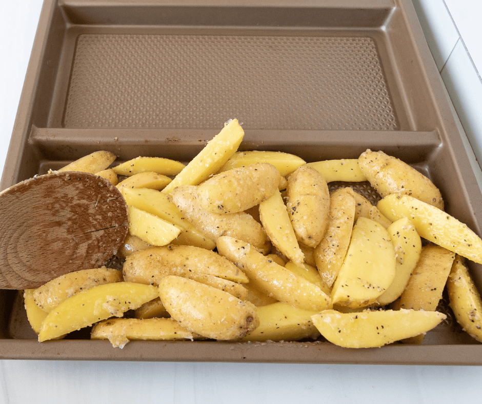 Uncooked roasted potatoes on a sheet pan 