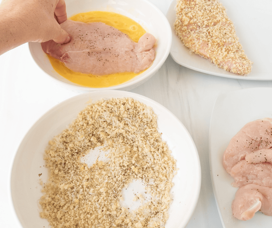 Dipping chicken in egg and breading 