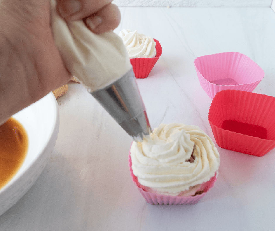 Piping cream on top of tiramisu