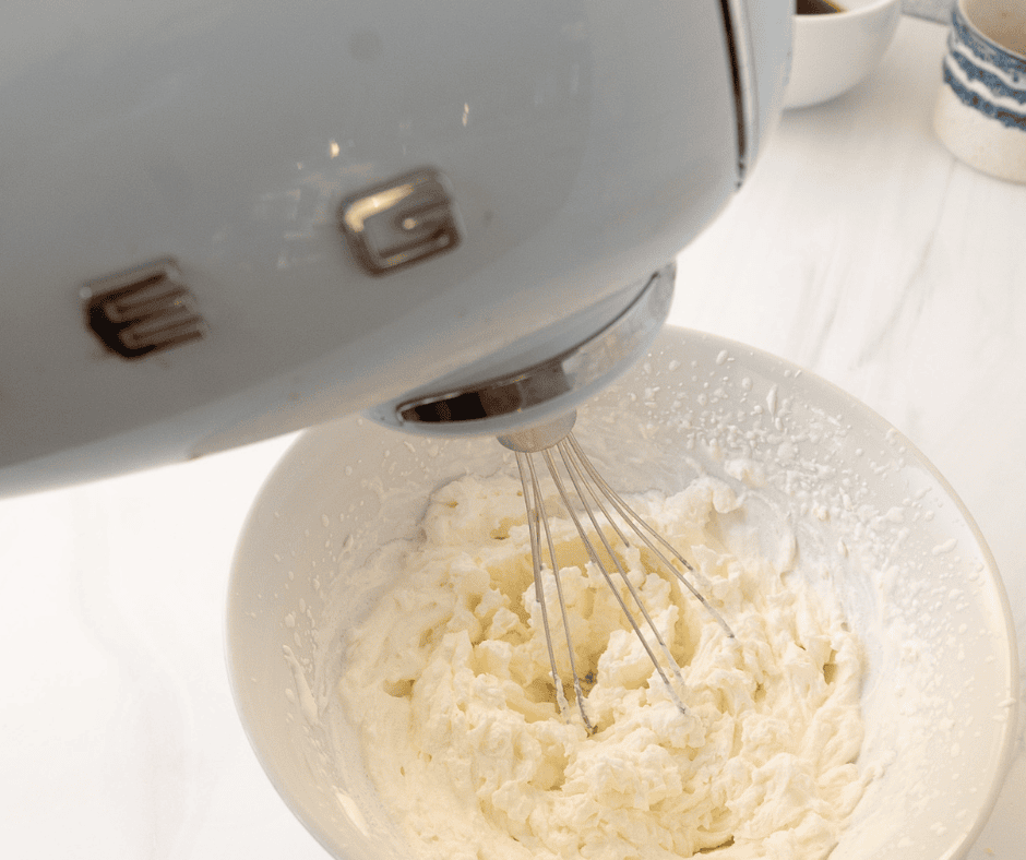 Mixing whipped cream with a hand mixer 