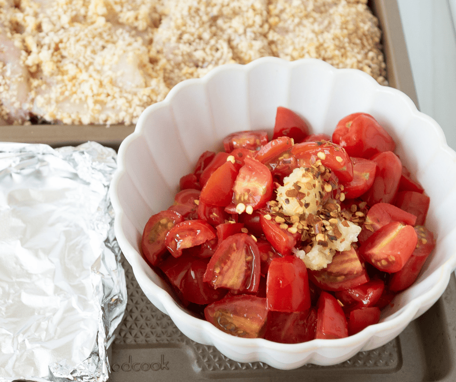 tomatoes and ingredients in a bowl ready to be mixed. 
