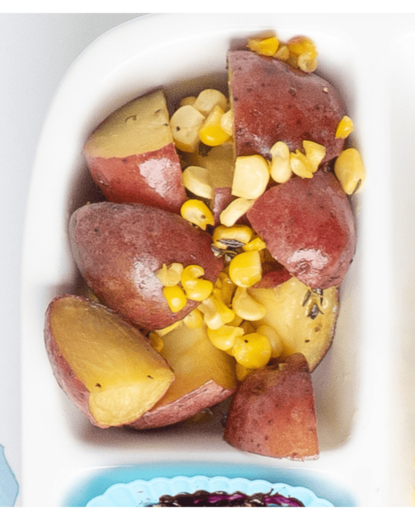 Close up or roasted potato and corn medley
