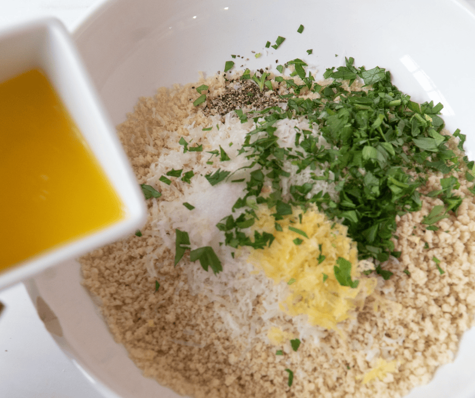 Process picture of pouring butter into panko crumbs with seasoning.