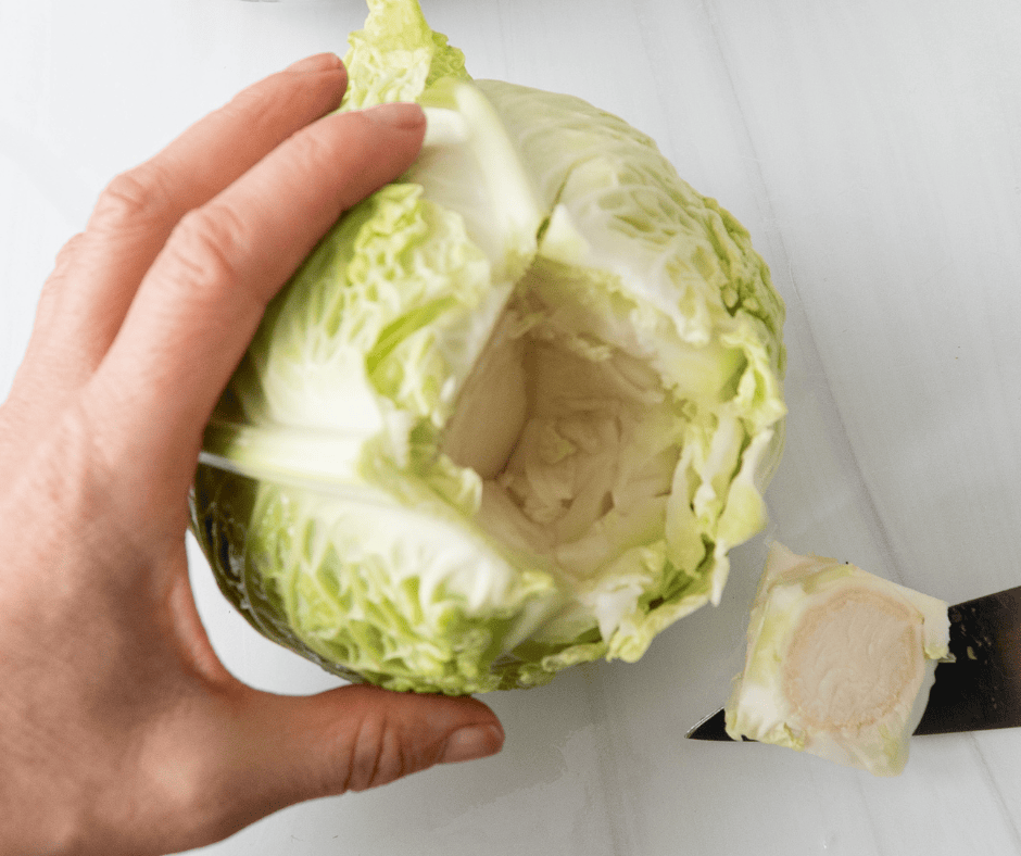 Cabbage being cored before steaming for Stuffed Cabbage recipe