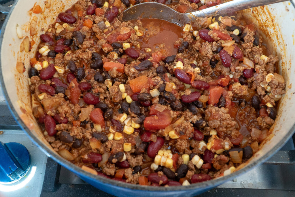 stirring final product for smoky turkey chili recipe