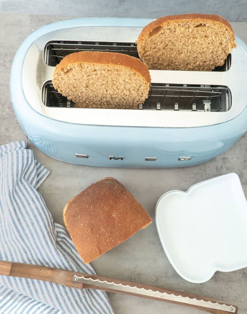 Slices of Honey Whole Wheat Bread in a light blue toaster. 