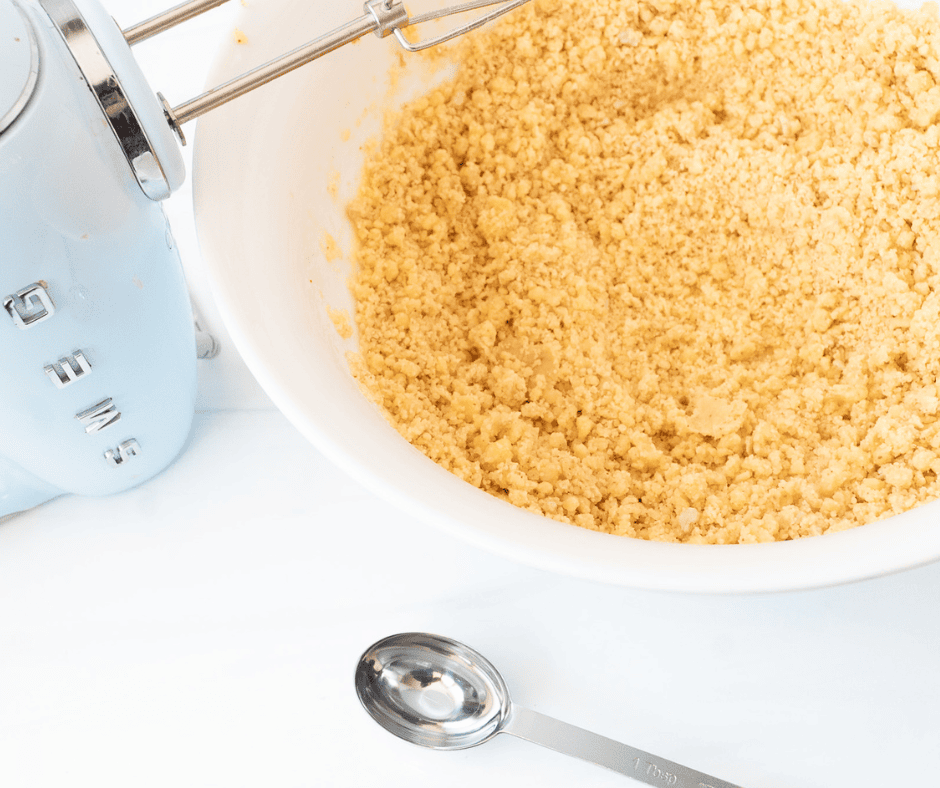 blue mixer next to a bowl of dough 