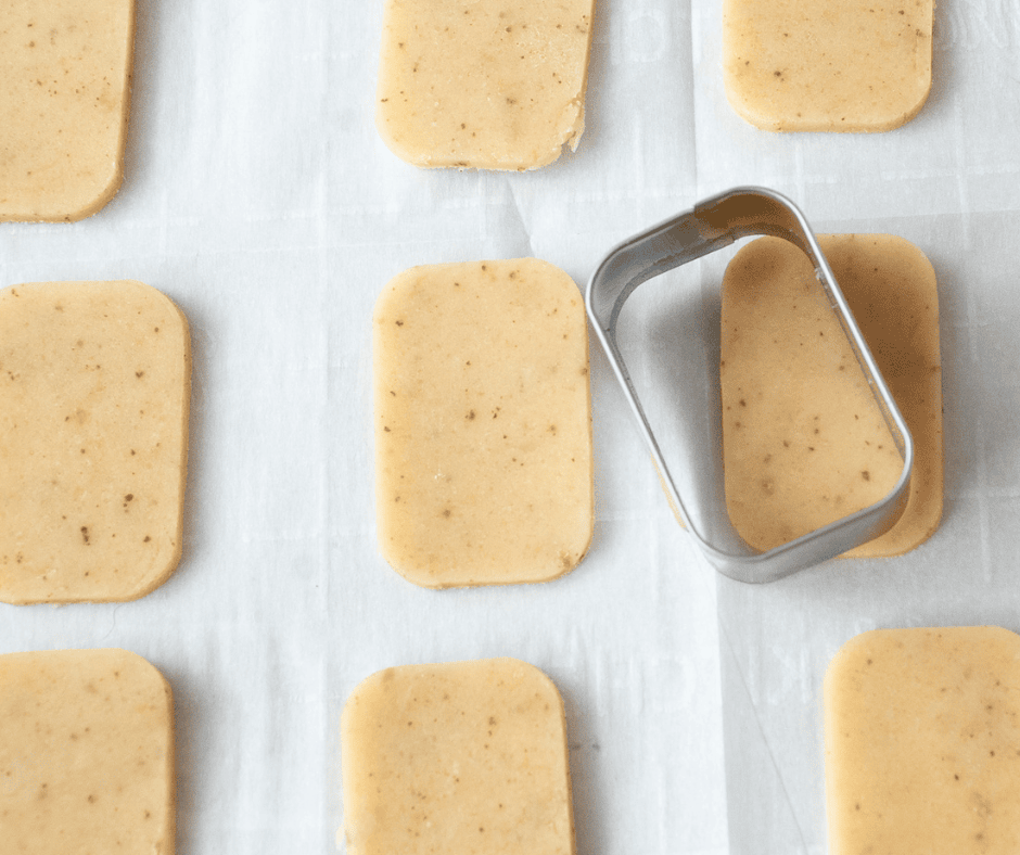 Close up of cut out cookies with a rectangular cookie cutter 