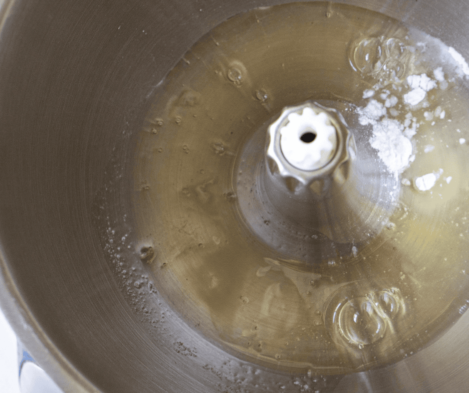 Room-temperature egg whites and cream of tartar in a stand mixer bowl before whipping