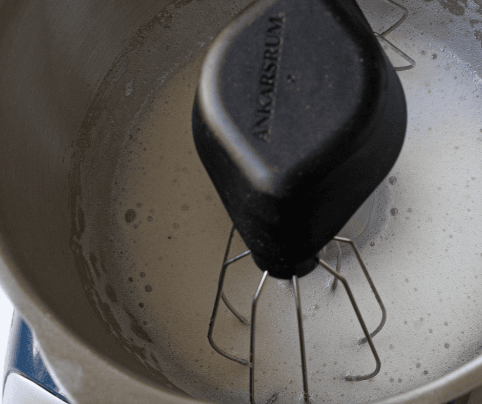 Egg whites whipped to a frothy stage in a stand mixer — the first step in making vanilla-almond meringues for this meringue snack mix