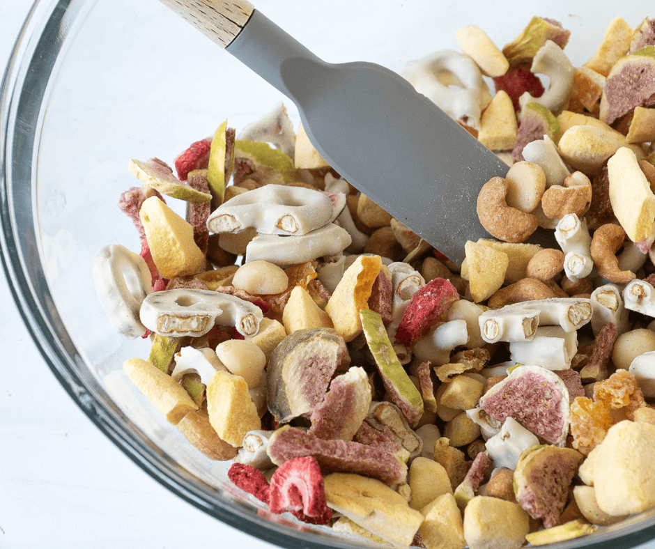 Tossing nuts, freeze-dried fruit, and yogurt pretzel shards together in a large glass bowl before folding in the meringues