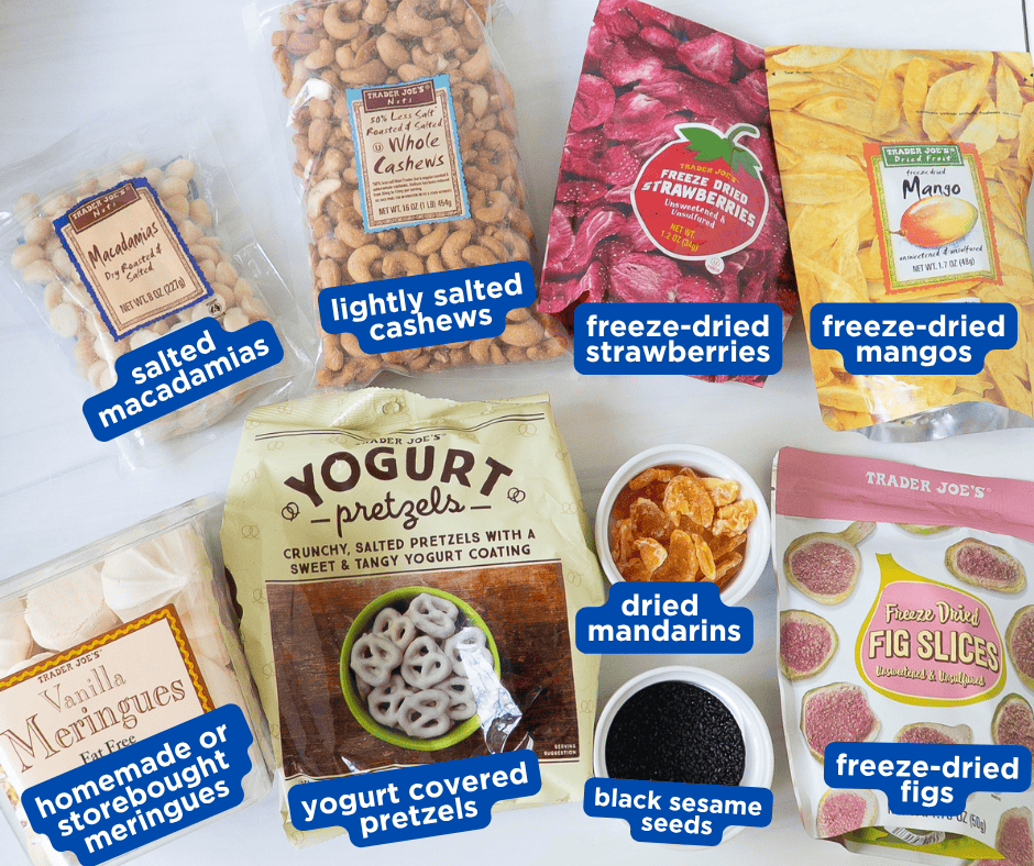 Trader Joe's ingredients for meringue snack mix including macadamias, cashews, yogurt pretzels, freeze-dried strawberries, mangos, figs, and dried mandarins